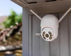 A security camera mounted on a house, monitoring the surroundings for enhanced safety and surveillance.